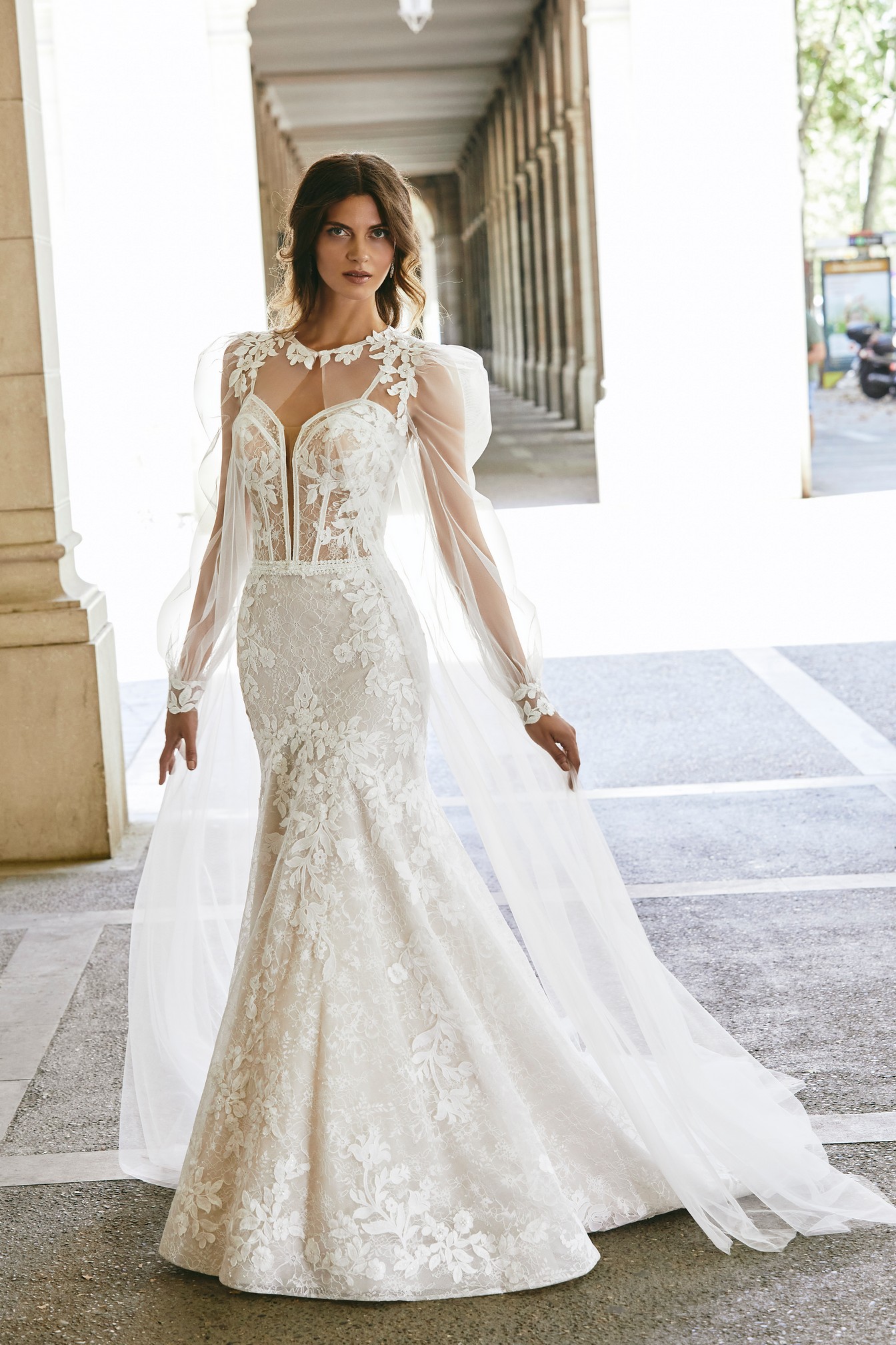 Model wearing the Ronald Joyce Victoria Jane wedding dress style 18620 and matching tulle and lace applique coat (style 18621).