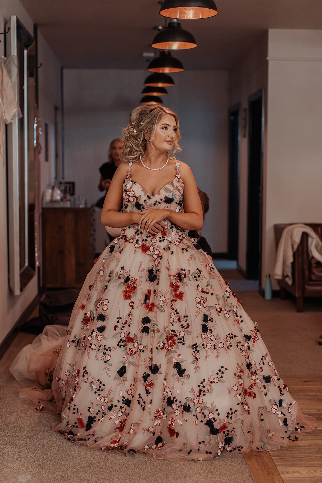 Ronald Joyce real bride, Rebecca, in her Celestina wedding dress, a blush ballgown with colourful floral appliques. 